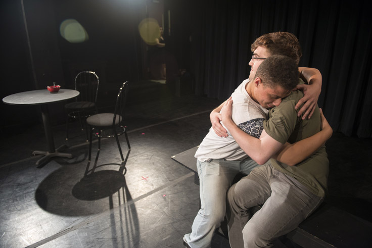 Two male actors hugging