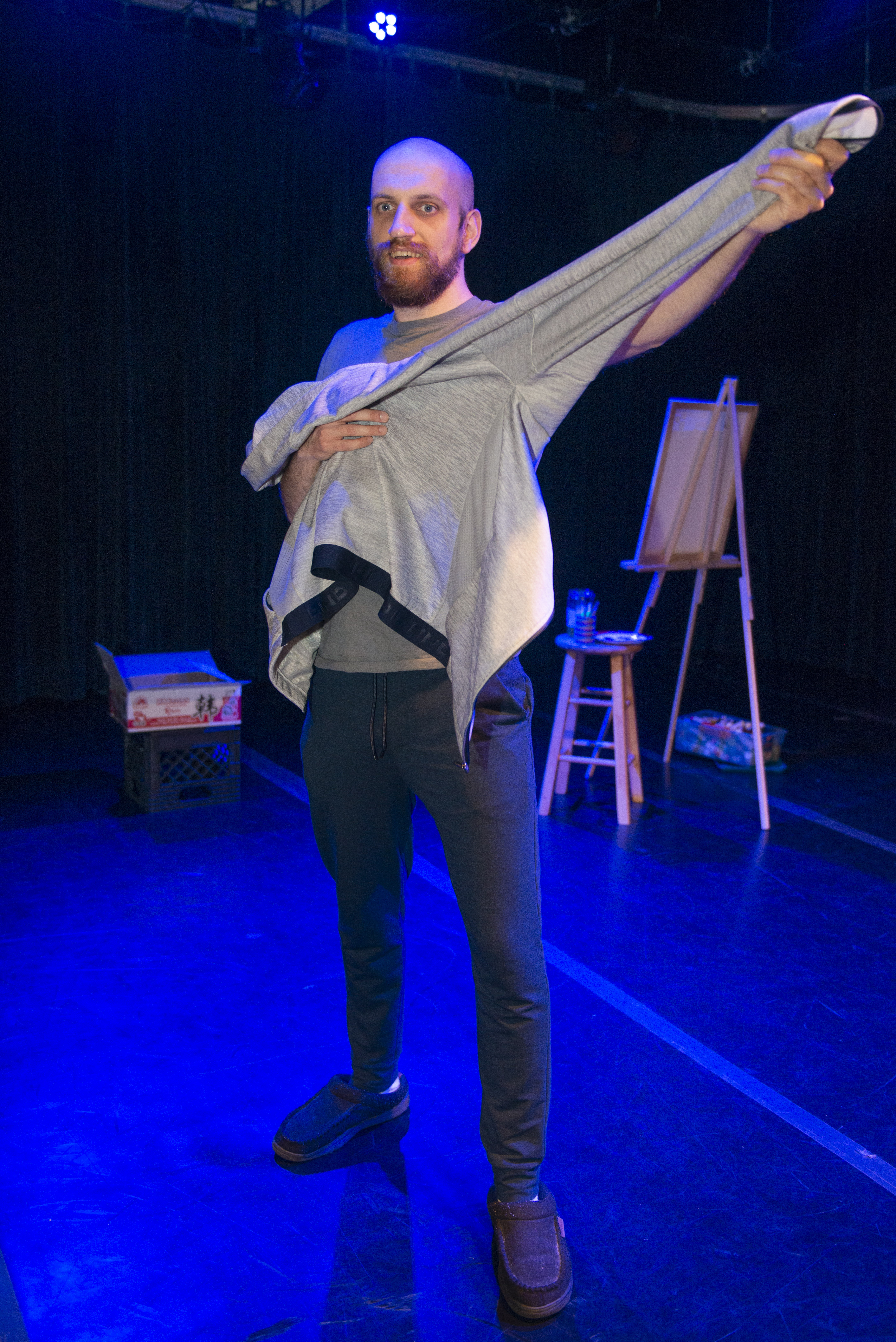 One theater student standing up and pointing 