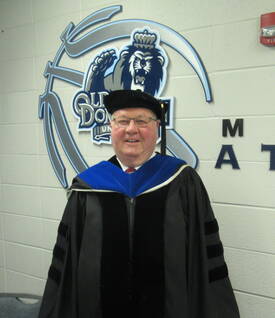 MCC Class of '68 member Al Cobb with cap and gown as he prepares to attend the December 2024 commencement of Tidewater Community College, Virginia
