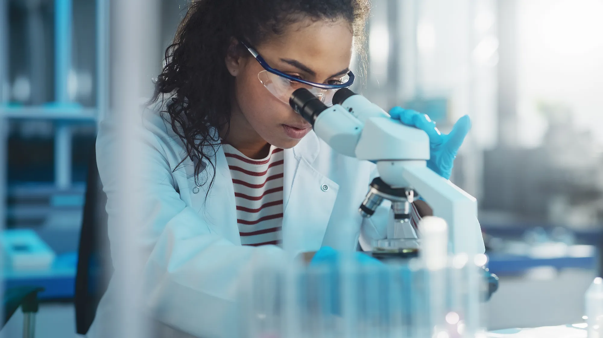 A student looking through a microscope 
