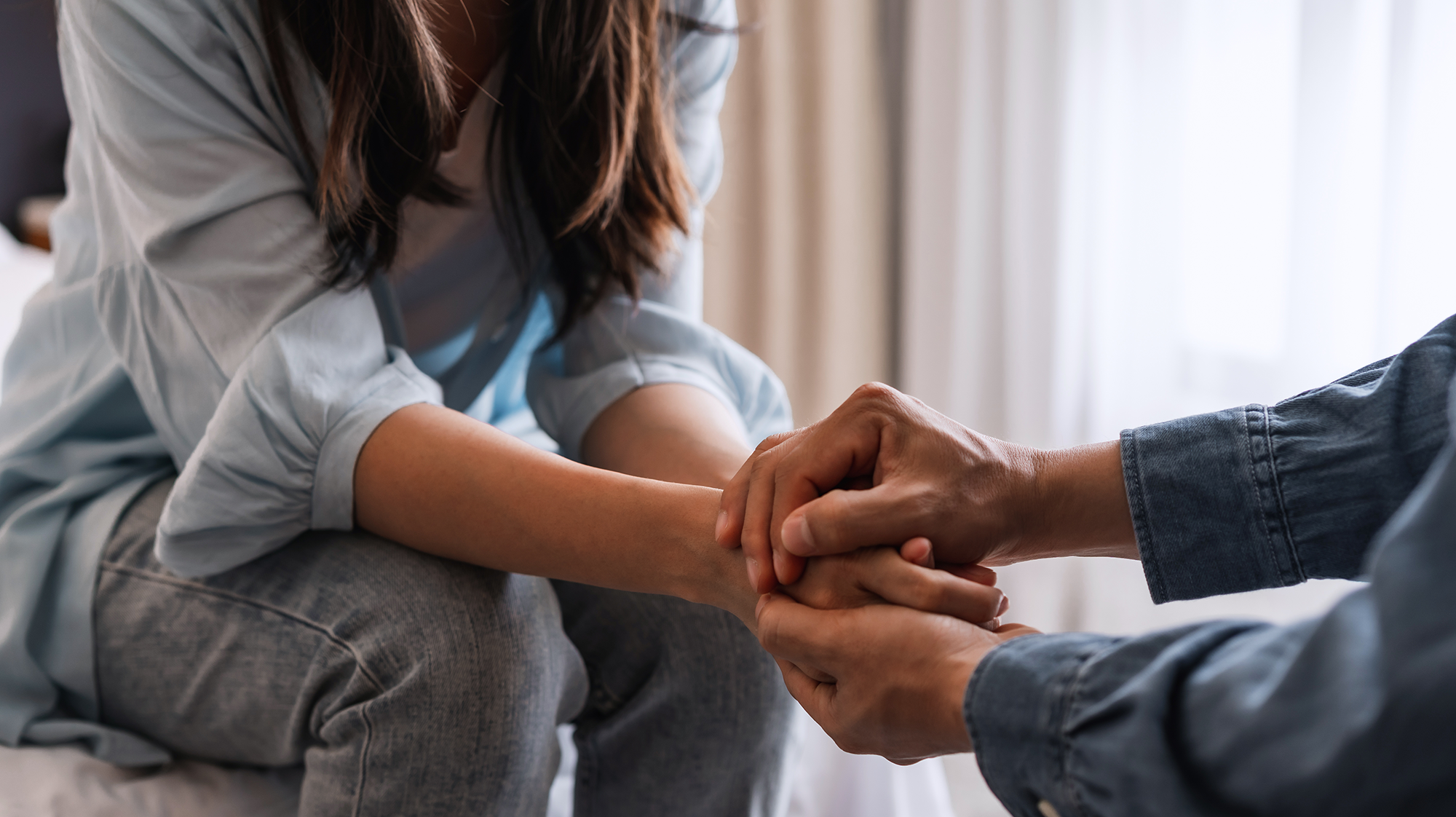 a close up of two people holding hands