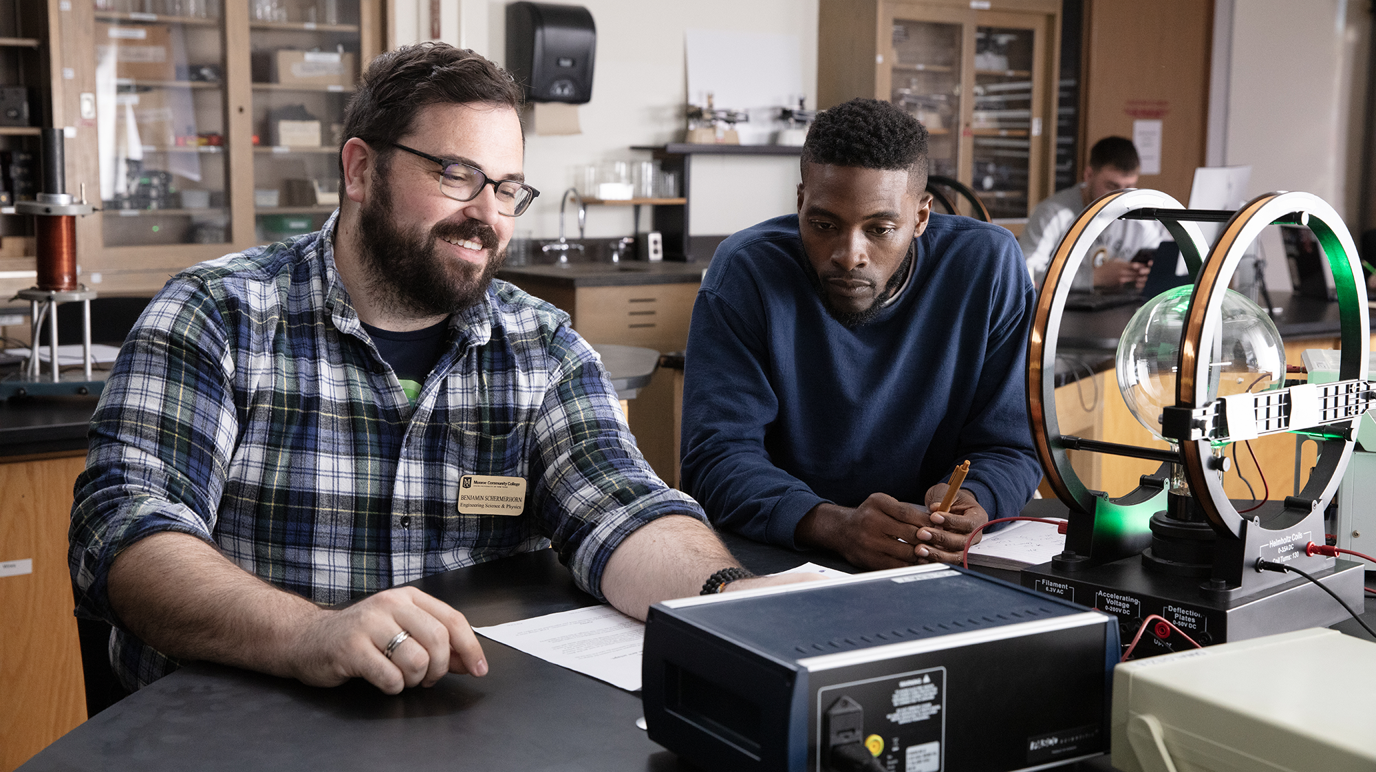 a professor helping a student with an engineering project
