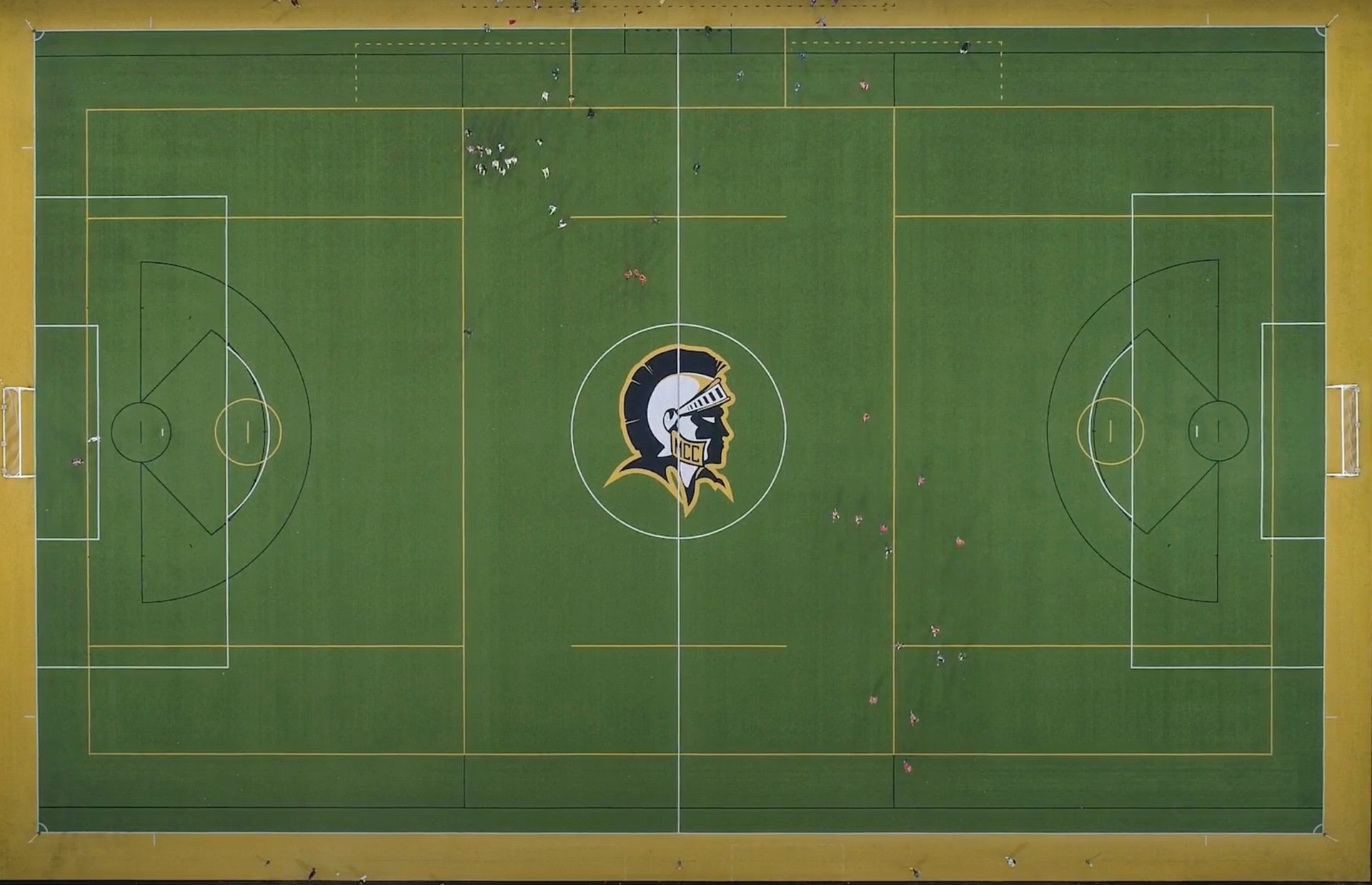 soccer field with mcc's Tribune head logo in the center